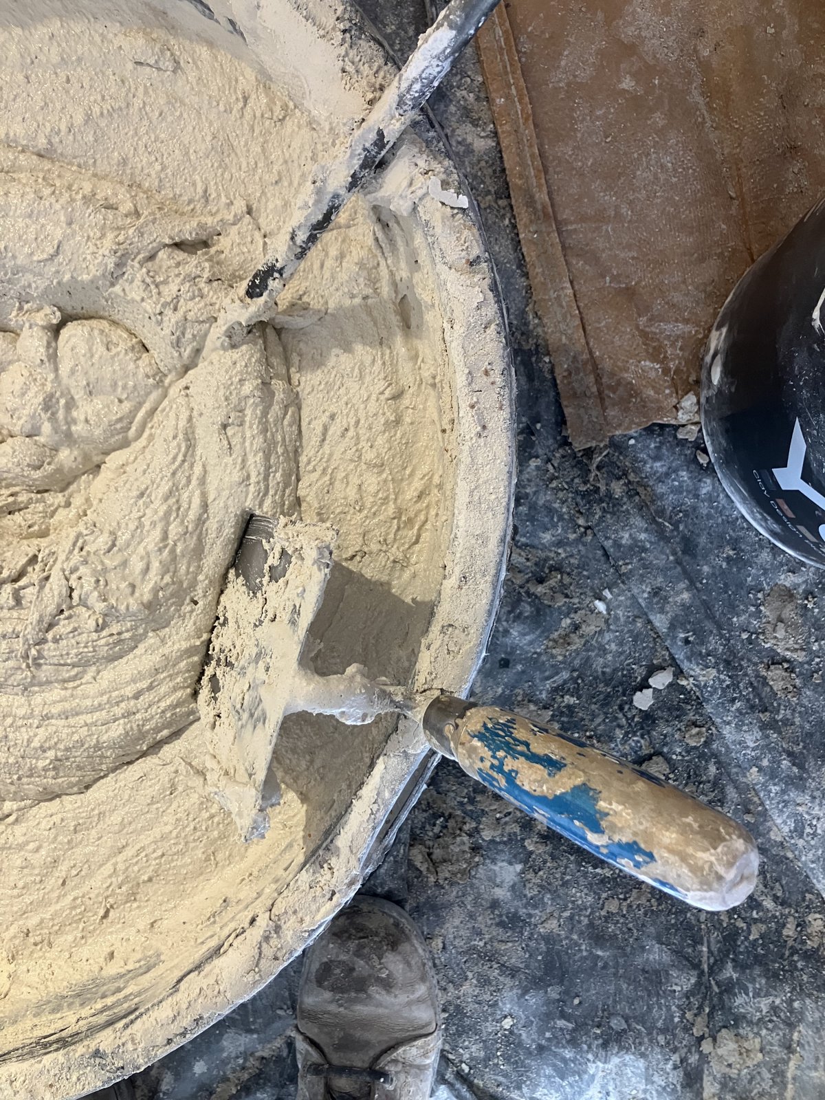 Préparation d’un enduit naturel : platoir et auge de mélange frais sur le chantier